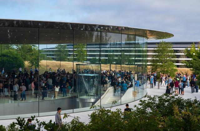 People walk through the Steve Jobs Theater prior to an event at the Apple Park campus in Cupertino, California, on September 12, 2023. The new Apple iPhone 15, with EU ordered USB-C charger, is expected to be announced, amongst other new products, during a launch event on September 12. (Photo by Nic Coury / AFP) (Photo by NIC COURY/AFP via Getty Images)