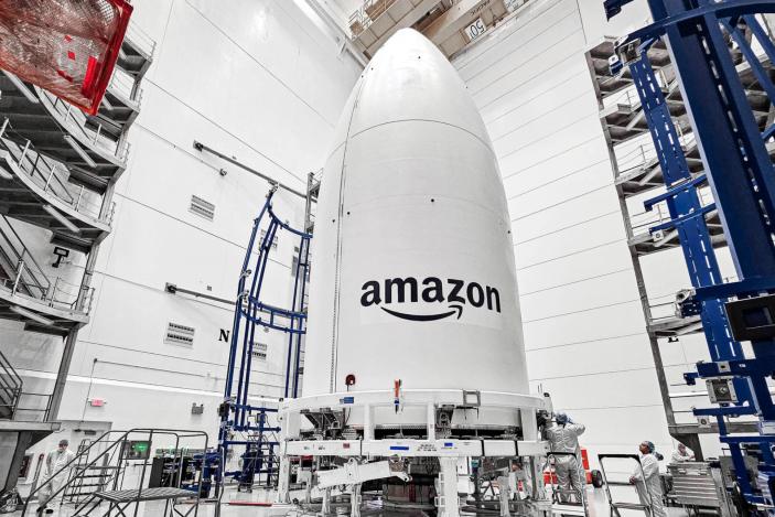 A white rocket payload with the Amazon logo.